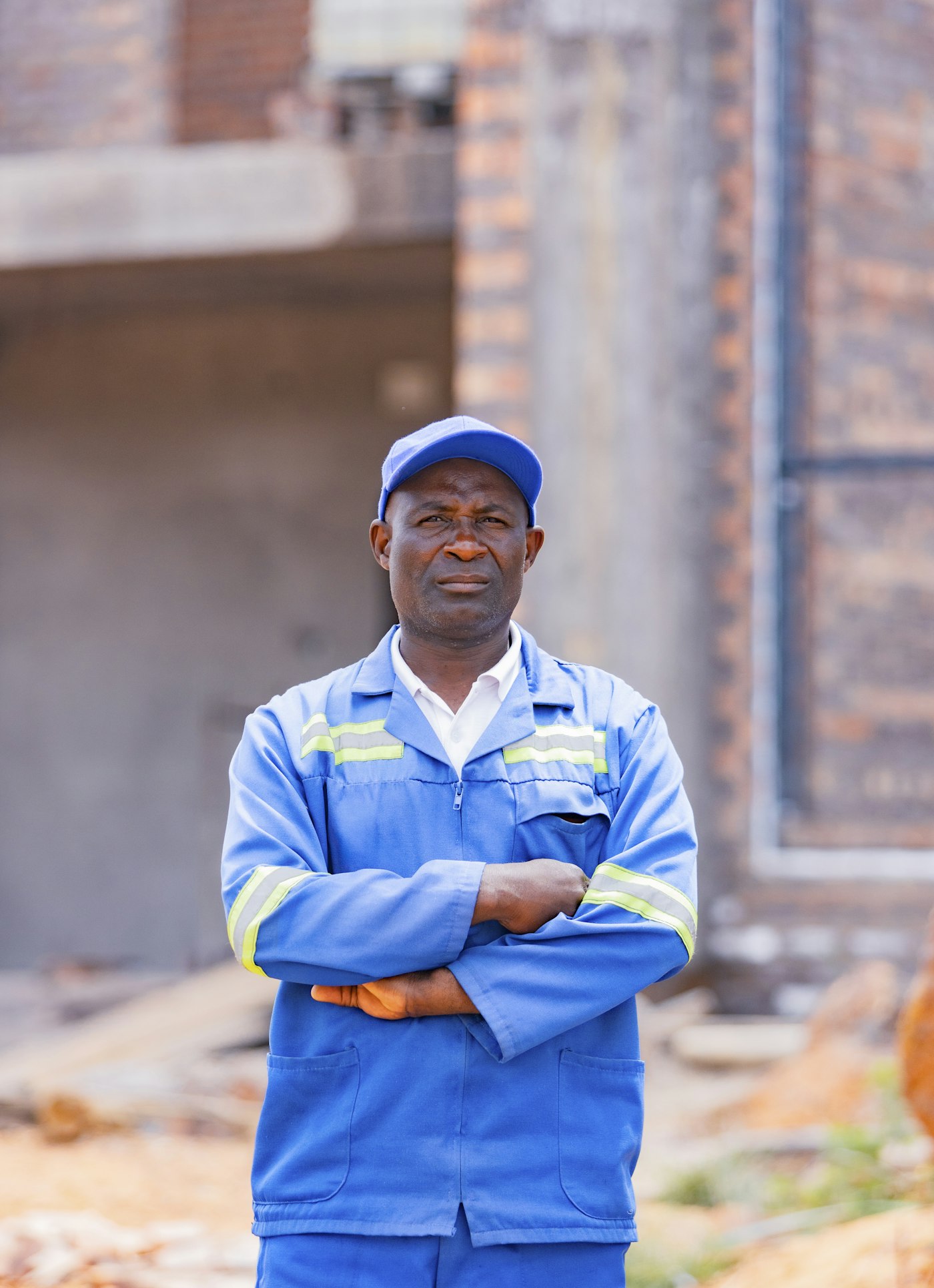 Tradesman on site with arms folded