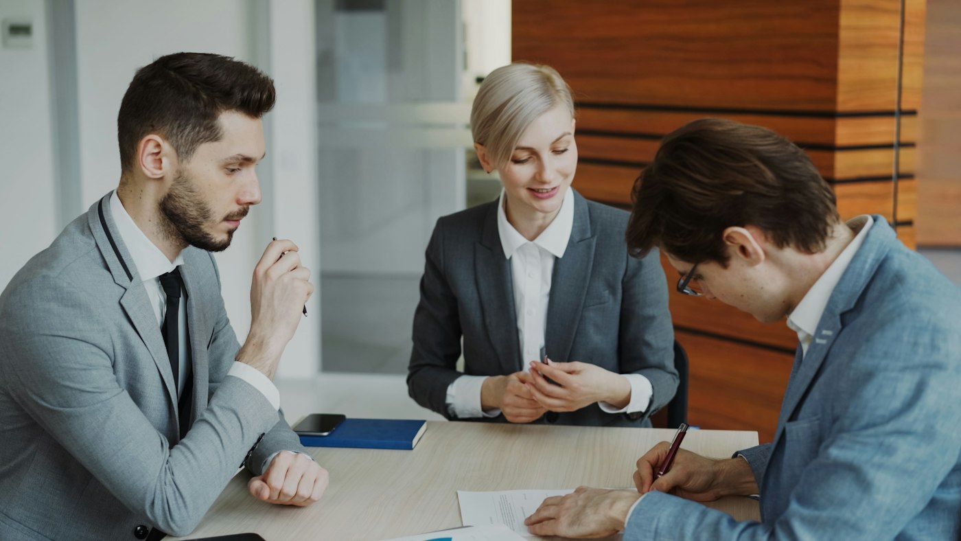 Signing a simple paper agreement at a desk