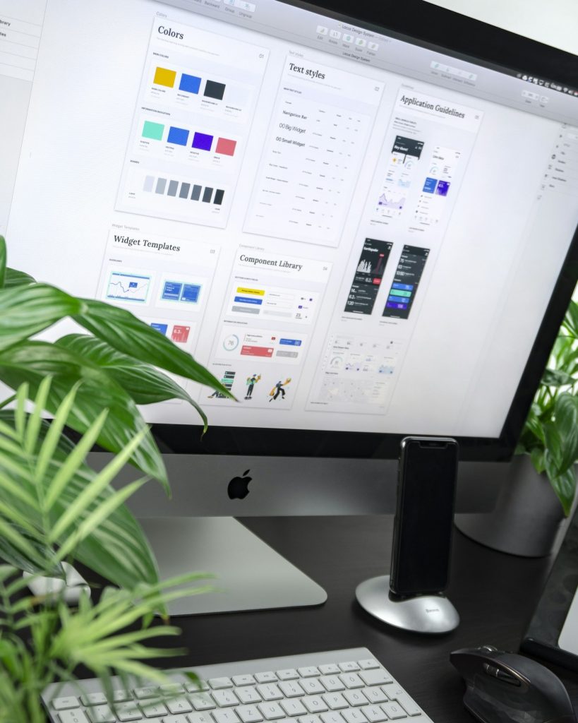 Website design layout and colour swatches on a screen